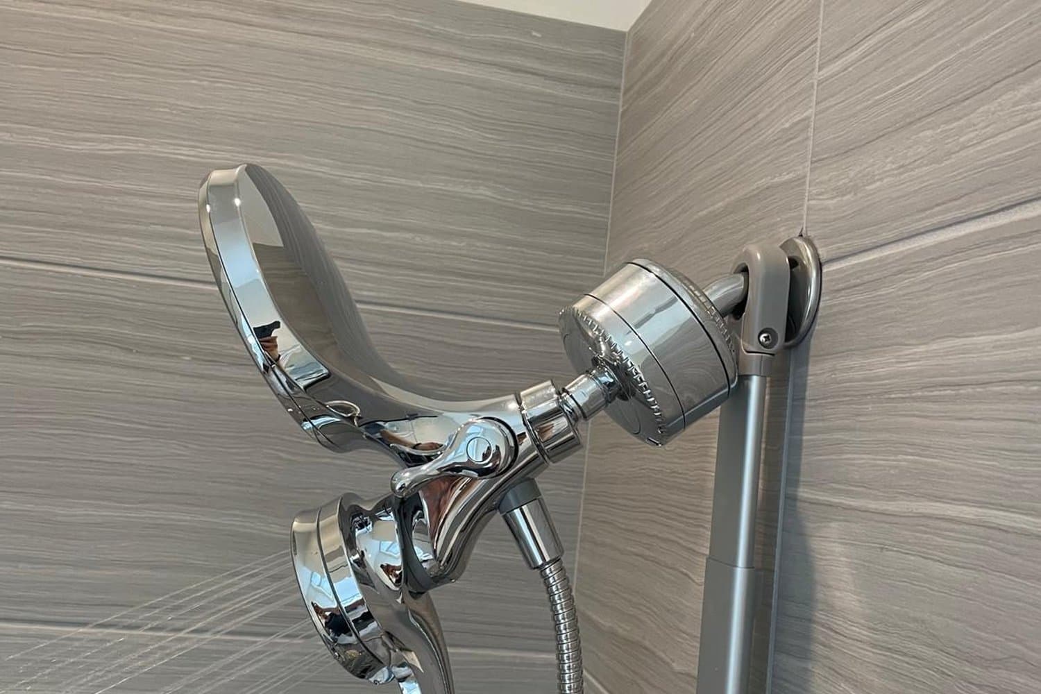 Newly installed chrome bathroom faucet and handheld sprayer in a Boston home