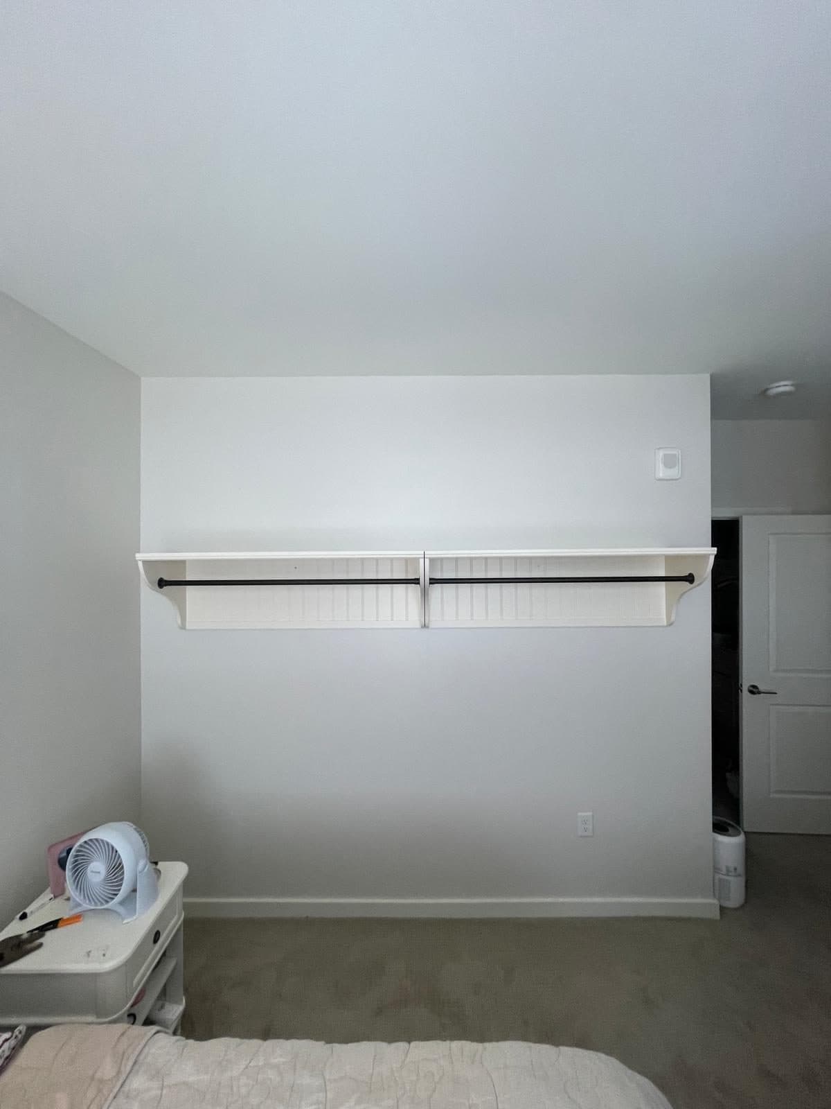 White floating wall shelves installed and leveled in a Boston room