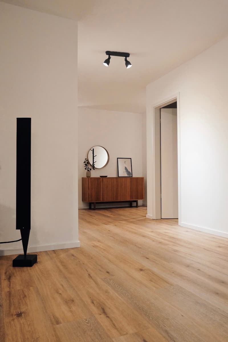 Newly installed light hardwood plank flooring in a bright room