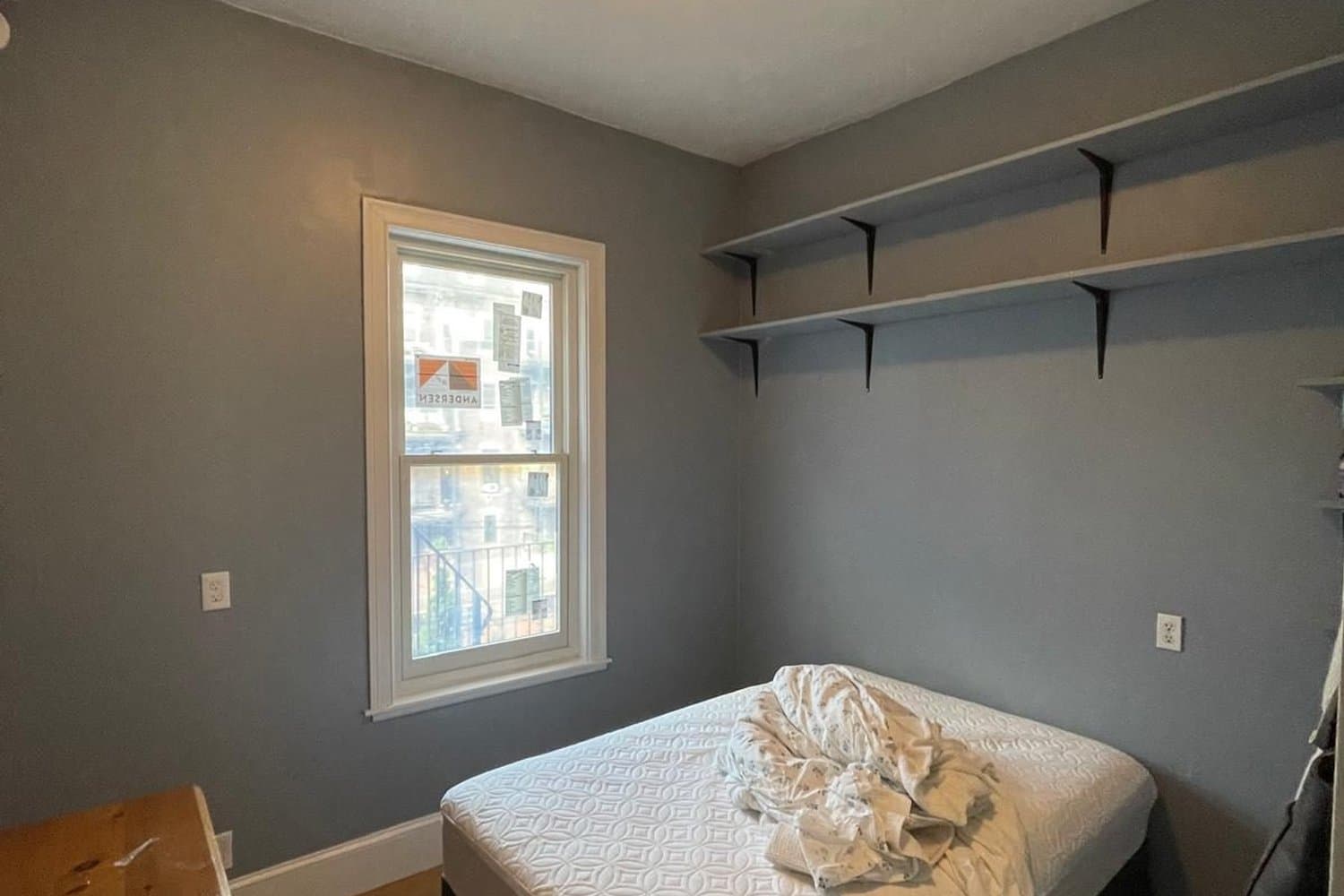 Freshly painted grey bedroom with new ceiling light in a Boston home