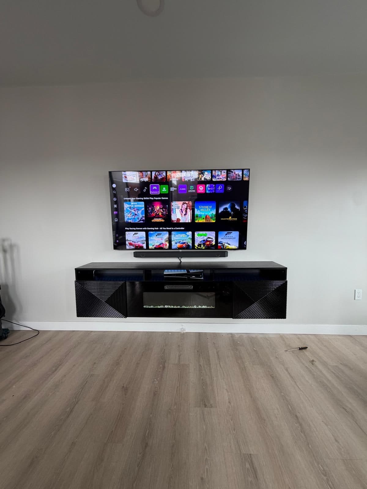 Flat-screen TV wall-mounted over a media console in a Boston apartment