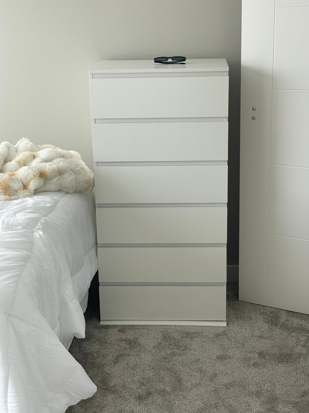 Tall white six-drawer dresser assembled in a Boston bedroom